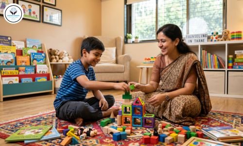 A friendly child psychologist in Thane conducting a therapeutic play session with a smiling Indian boy at Sound Minds clinic